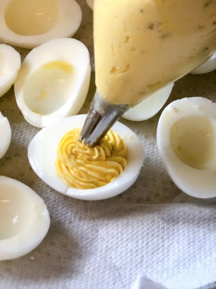 filling deviled eggs with plastic bag fitted with cake decorating tip