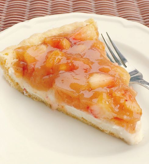 Slice of spiced peach pie on white plate