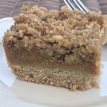 three layer pumpkin bars on plate with fork