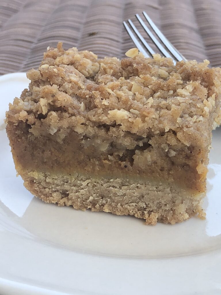 three layer pumpkin bars on plate with fork