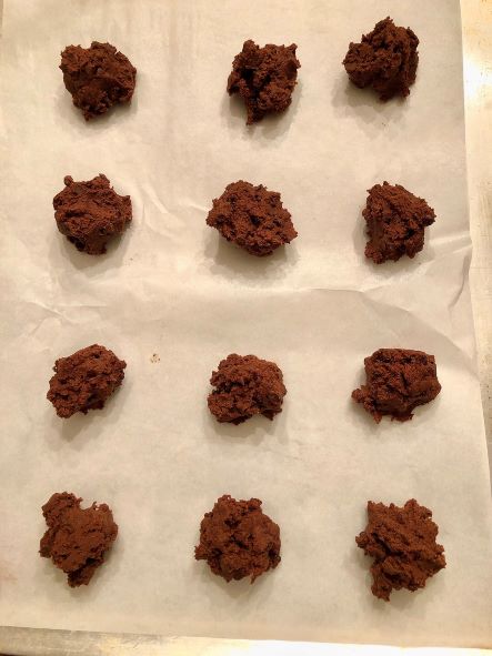chocolate chocolate chip cookie dough spaced two inches apart on parchment paper lined baking sheet