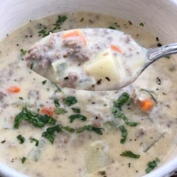 chunky cheeseburger soup in bowl with spoonful