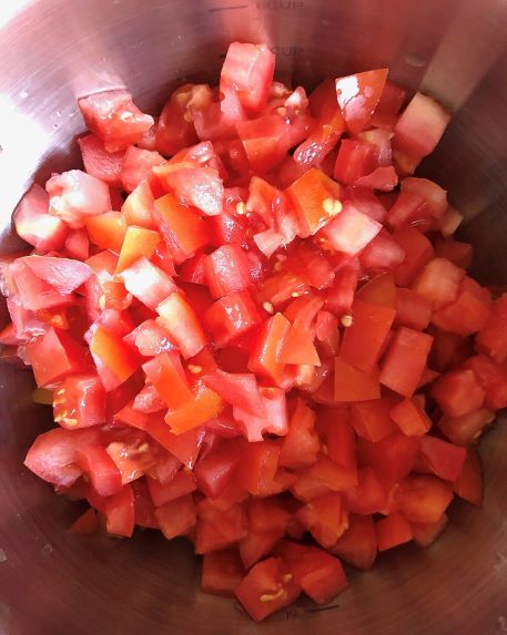 diced tomatoes in a metal bowl