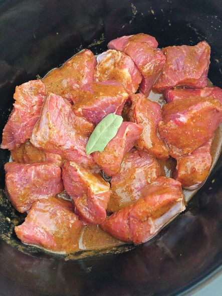 chuck roast in crock pot with bay leaf for chipotle barbacoa recipe
