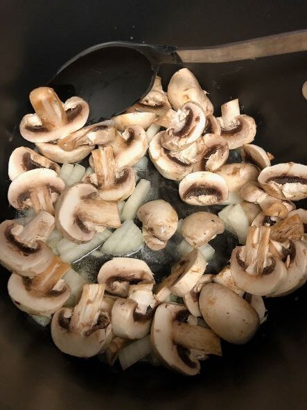 mushrooms and onion cooking in pot