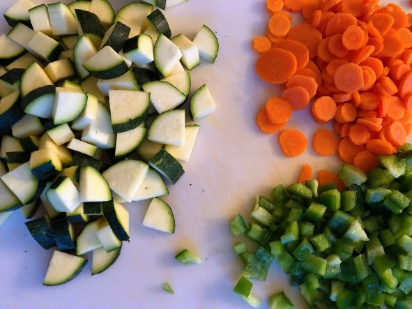 chopped bell pepper, chopped zucchini, and sliced carrots on cutting board