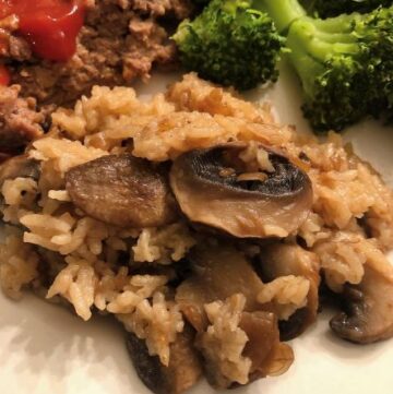 mushroom rice casserole plated with broccoli and meatloaf