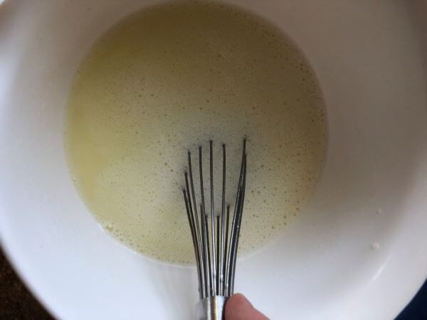 whisking butter and water together in bowl