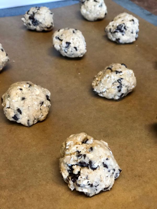 cookie dough rolled into walnut-sized balls space two inches apart