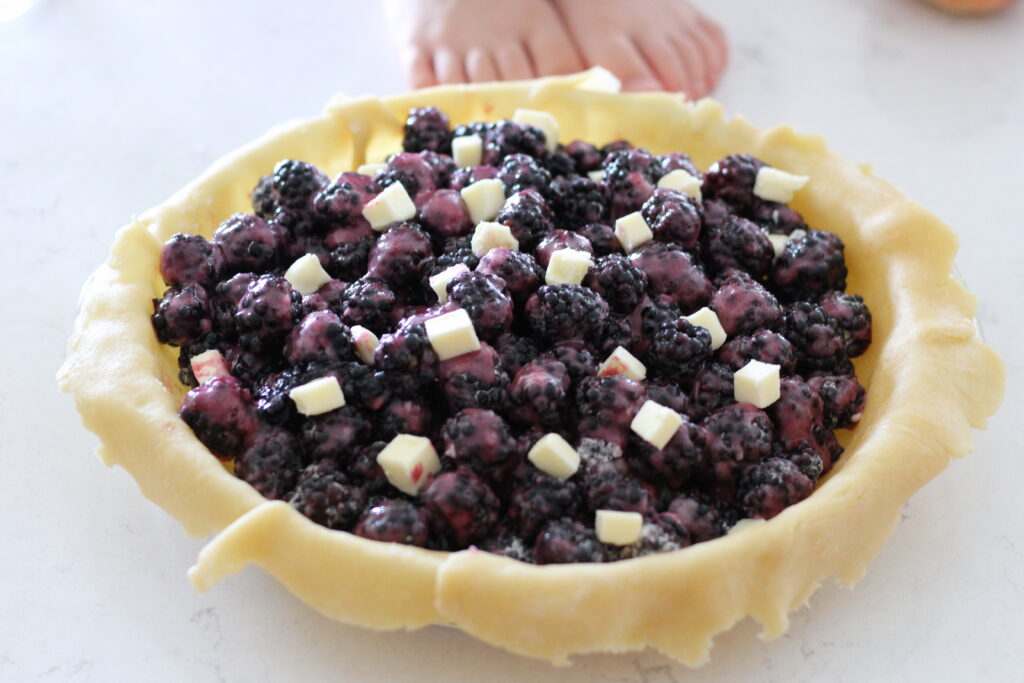 little feet kids making blackberry pie