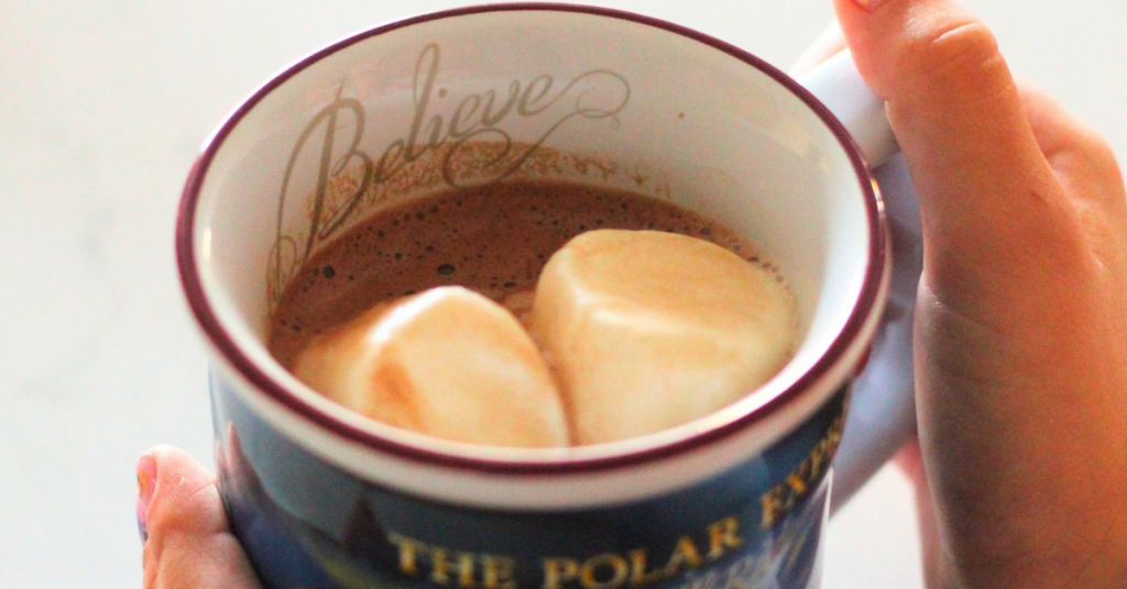 hot cocoa in a Polar Express mug with marshmallows